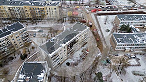 Drone photography of aftermath multistory residential building fire and emergency service cleaning up during winter day