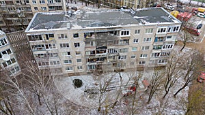 Drone photography of aftermath multistory residential building fire and emergency service cleaning up during winter day