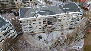 Drone photography of aftermath multistory residential building fire and emergency service cleaning up during winter day