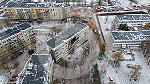 Drone photography of aftermath multistory residential building fire and emergency service cleaning up during winter day