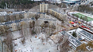 Drone photography of aftermath multistory residential building fire and emergency service cleaning up during winter day