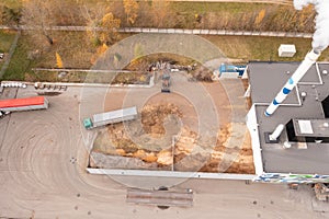 Drone photography of biomass power plant and biomass storage place during autumn day