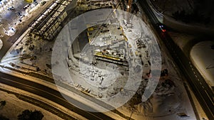 Drone photography of construction site and construction workers working during winter night