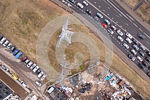 Drone photography of electrical transmission tower line in the middle of city during spring morning