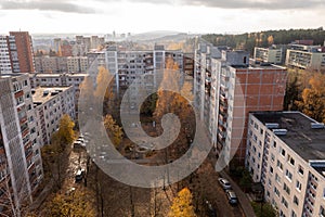 Drone photography of multistory houses and park between them in a city during autumn day