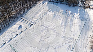 Drone photography of soccer, basketball and volleyball fields covered by snow during winter day