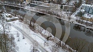 Drone photography of winter cityscape and river flowing through it during winter day