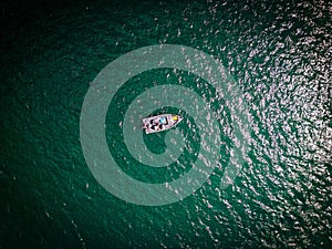 Drone picture from above of a boat on Lake Norfork, Arkansas, USA photo