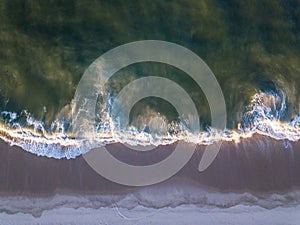 Drone picture of waves hitting the beach
