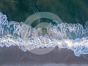 Drone picture of waves hitting the beach