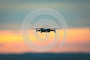 Drone pilotage on the sky at sunset