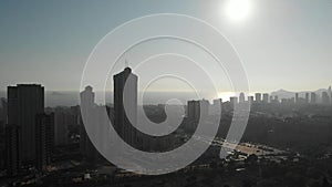 Drone point of view Benidorm cityscape during sunny winter day. Tall highrise modern residential and office building exterior,