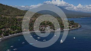 Drone point view to Amed beach and volcano Agung at background at sunny day