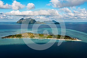 Drone point of view of tropical island Maiga near Tun Sakaran Marine Park