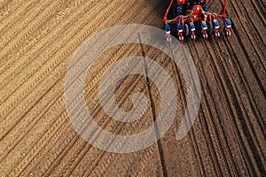 Drone pov tractor sowing corn in field photo