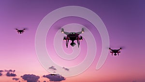 Drone quadcopter with digital camera flying in sunset evening time Beautiful light of nature background