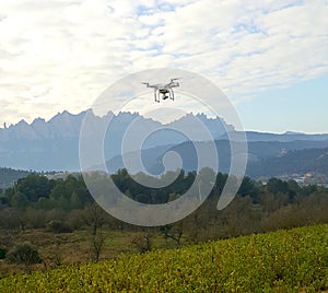 Drone quadcopter flying at a landscape