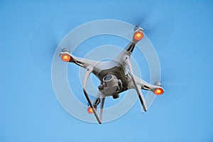 Drone quadrocopter hovering in blue sky