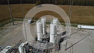The drone rises above the storage tanks for gaseous substances. Industrial tanks of an air separation plant, vertical