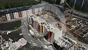 the drone rotates over a high-rise building under construction on the outskirts of the city.