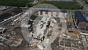 the drone rotates over a high-rise building under construction on the outskirts of the city