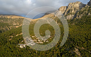 Drone scenery mikro Papingo village , Zagorochoria area, Epirus, Ioannina Greece. Astraka tower rocky cliffs above the village at