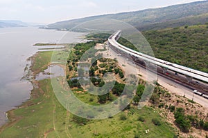 Drone shot aerial view landscape of under construction motorway tolls near big natural river