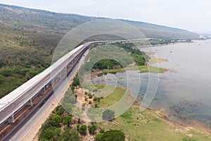 Drone shot aerial view landscape of under construction motorway tolls near big natural river