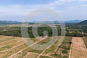 Drone shot aerial view scenic landscape of agriculture farm against mountain and nature forest