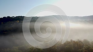 Drone shot, aerial view of Umbria, Tuscany in Italy. Sunrise with fog in early morning.