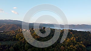 Drone shot, aerial view of Umbria, Tuscany in Italy. Sunrise with fog in early morning.