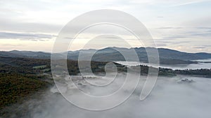 Drone shot, aerial view of Umbria, Tuscany in Italy. Sunrise with fog in early morning.