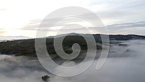 Drone shot, aerial view of Umbria, Tuscany in Italy. Sunrise with fog in early morning.