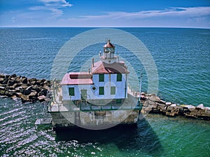 Drone shot of the Ashtabula Harbor Light building under a cloudy sky in Ohio, USA