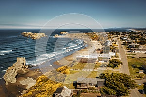 Drone shot of Bandon Oregon coastal homes real estate overlooking beach.