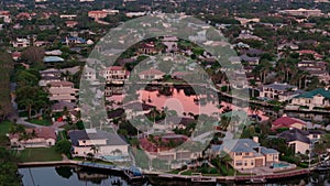 Drone shot of the bay and buildings in the city of Naples, Florida on sunset time