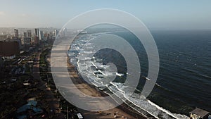 Drone shot of a beachline with sea and misty sky