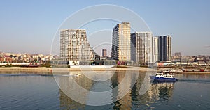 Drone shot of Belgrade waterfront and a passing boat