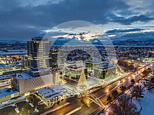 Drone shot of buildings and a light Christmas tree in Kelowna, British Columbia, Canada