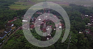 Drone shot of Cellular antenna in the middle of tropical village in the morning