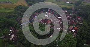 Drone shot of Cellular antenna in the middle of tropical village in the morning