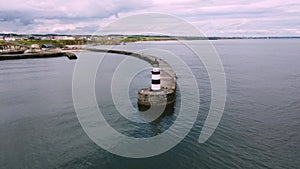 Drone shot circling above Seaham lighthouse and pier in 4k, Durham, UK