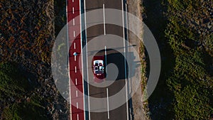 Drone shot of convertible vintage red car on road