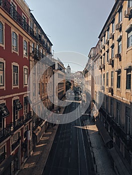 Drone shot of the empty street among old buildings in the Campolide neighborhood in Lisbon, Portugal