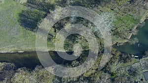 Drone shot flying forward on spring river in forest. Aerial view of spring landscape river.