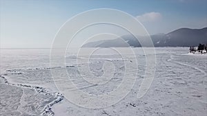 Drone shot following a dog team on lake Baikal.