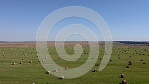 Drone shot of hay bales on a clear sunny day