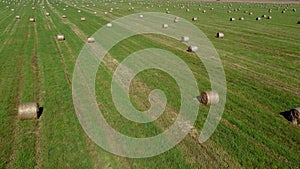 Drone shot of hay bales on a clear sunny day