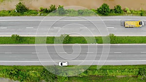 Drone shot high angle Aerial view of highway traffic at the countryside, The car truck and motorcycle transport