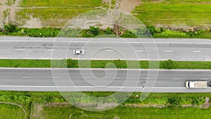 Drone shot high angle Aerial view of highway traffic at the countryside, The car truck and motorcycle transport